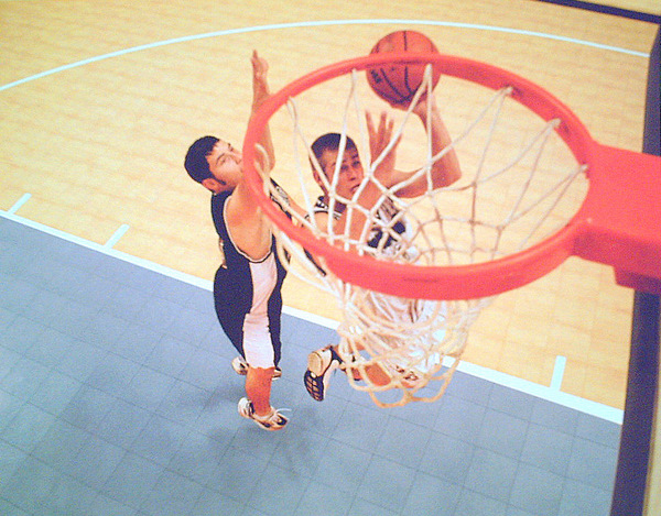 Kid's playing basketball on an indoor Sport Court gym.